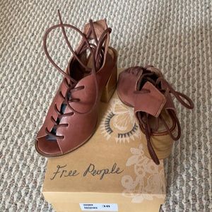 Free people lace up block heel sandal.